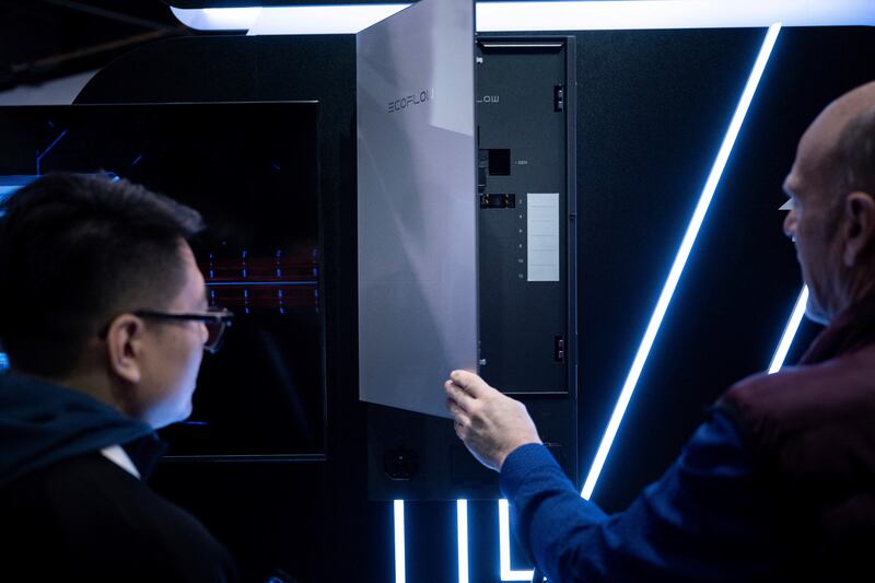 People look at a power bypass panel to use batteries from Ecoflow to power your home at the Consumer Electronics Show (CES). Photograph: Brendan Smialowski/AFP via Getty