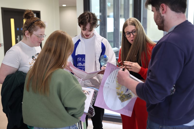 Students  Tammy Carter, Susan Walsh, Páidí Malone, Lucy McEvoy and Finn Skehill, looking over their exam papers at Belmayne Educate Together Secondary School. Photograph: Dara Mac Dónaill







