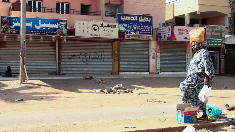 A woman walks past shuttered shops in Sudan’s capital,  Khartoum, on Thursday. Photograph: AFP via Getty Images