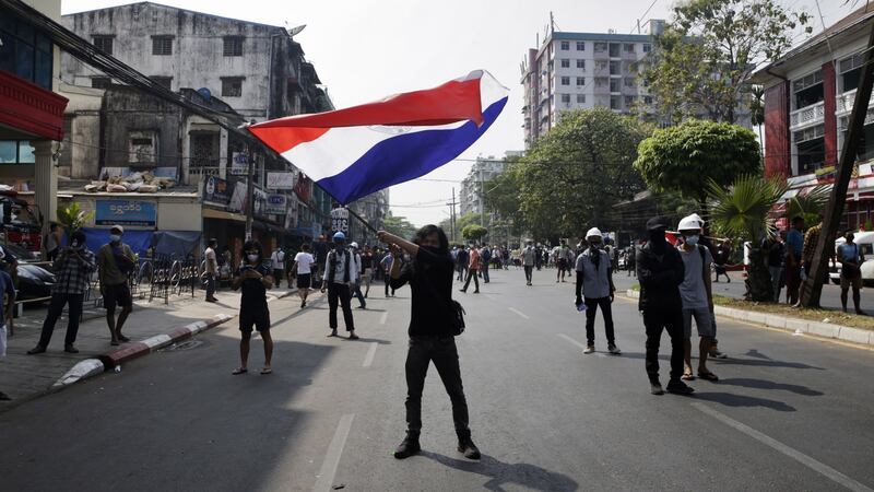 A demonstrator waves a flag on a road during a protest against the military coup in Yangon, Myanmar. Photograph: Lynn Bo Bo/EPA