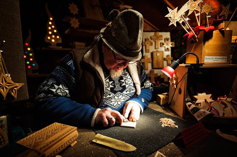 Wood carving at a Christmas market. Photograph: Florian Trykowski. ©DZT/Florian Trykowski