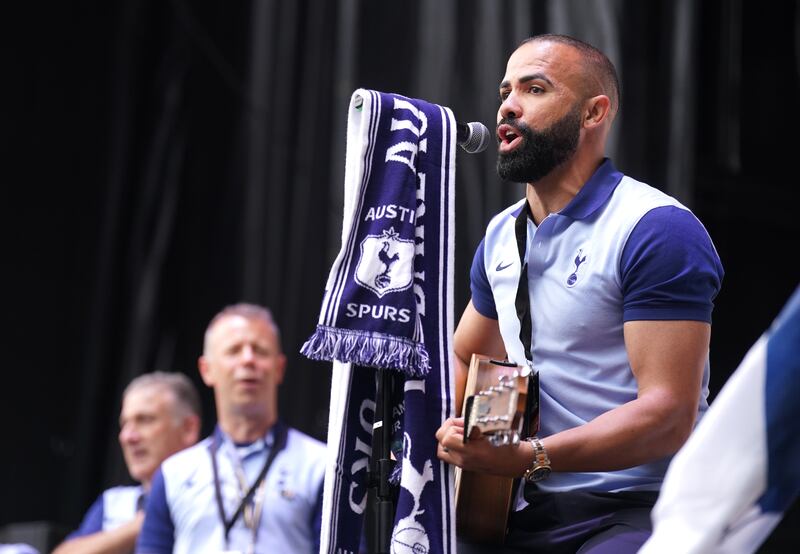Former Tottenham Hotspur player Sandro plays guitar with the band on stage at the Ametzola Park fan zone in Bilbao before the UEFA Europa League final at the Estadio de San Mames in Bilbao. Photograph: Adam Davy/PA