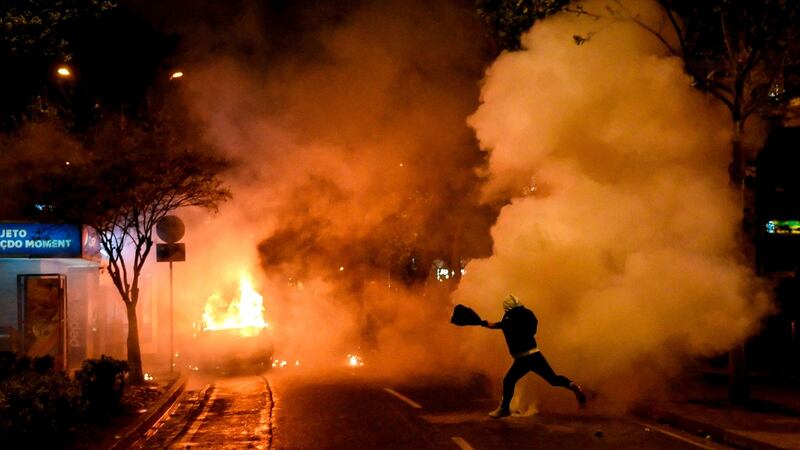 A vehicle ablaze during anti-government protests in the Albanian capital Tirana on Saturday. Photograph:  Gent Shkullaku/Getty