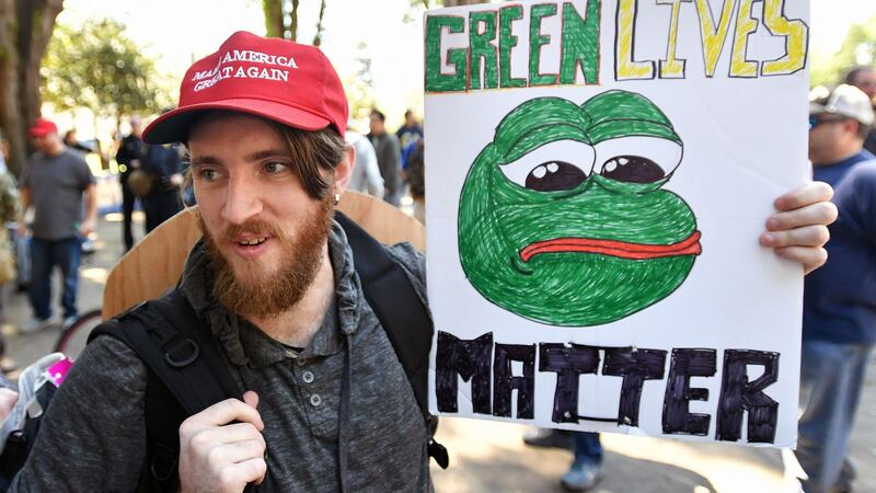 Protester Andrew Knight holds a sign depicting Pepe the Frog during a rally at Berkeley, California on April 27th after  conservative firebrand Ann Coulter cancelled a planned appearance at the University of California. Photograph: Josh Edelson/AFP/Getty Images