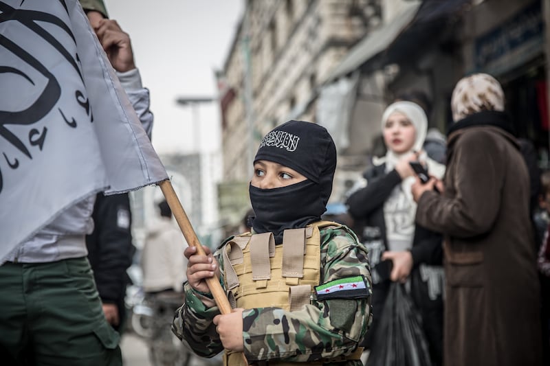 Children dress up as rebels in Homs. Photograph: Sally Hayden