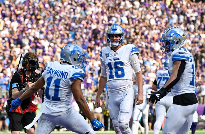  Jared Goff celebrates with Kalif Raymond and Amon-Ra St. Brown after a Detroit Lions touchdown against the Minnesota Vikings. Photograph: Stephen Maturen/Getty Images