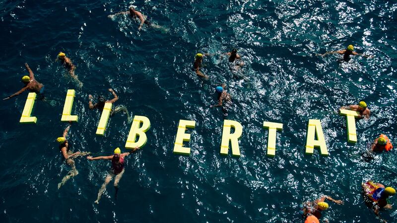 People swim around  floating letters forming the word “Freedom” in Catalan during a pro-independence gathering  in Badalona, close to Barcelona. Photograph: Josep Lago/AFP