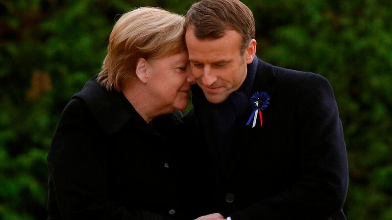 French president Emmanuel Macron and German Chancellor Angela Merkel hug after unveiling a plaque in a French-German ceremony in the clearing of Rethondes  (the Glade of the Armistice) in Compiegne, northern France on Saturday. Photograph: Philippe Wojazer/Pool/AFP/Getty