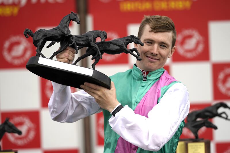 Jockey Colin Keane celebrates with the trophy after winning the Dubai Duty Free Irish Derby with horse Westover. Photograph: PA Wire