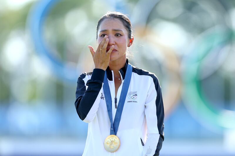 Olympic gold medalist Lydia Ko of Team New Zealand reacts on the podium. Photograph: Andrew Redington/Getty