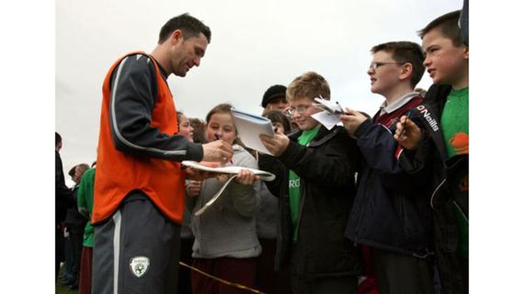 Republic of Ireland and Tottenham striker Robbie Keane signs
autographs after yesterday's training session at Malahide.
