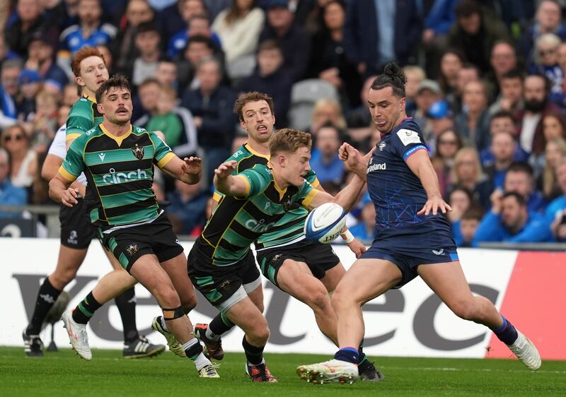 James Lowe kicks away from an incoming tackle by Northampton Saints's Fin Smith. Photograph: Niall Carson/PA 

