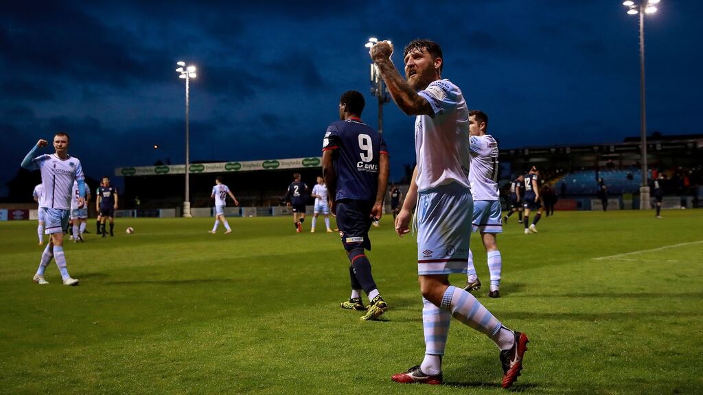 Drogheda’s Gary Deegan celebrates his team’s win over St Pat’s with fans watching from outside the ground. Photograph: Tommy Dickson/Inpho