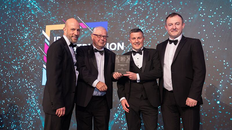 James Mcnamara, awards judge, presents the civil construction project of the year award to Arcadis Team.