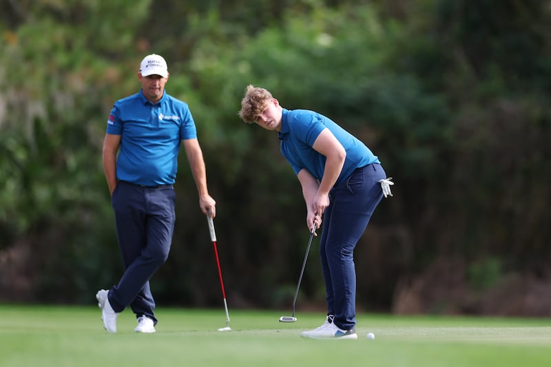 Paddy Harrington putts on the sixth green as Pádraig Harrington of Ireland looks on. Photograph: Mike Ehrmann/Getty