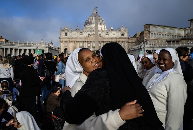 Nuns hug in front of St Peter's Basilica before the  funeral ceremony gets underway. Photograph JEFF PACHOUD / AFP) 