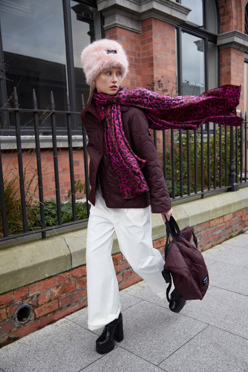 Pretty in pink: recycled pink fur headband €75, burgundy quilted wax cotton jacket with a wool filling €295, large scarf in recycled silk €75, wax cotton bag €150 - all from Yawuw. White pants and boots are from Beautiful South.