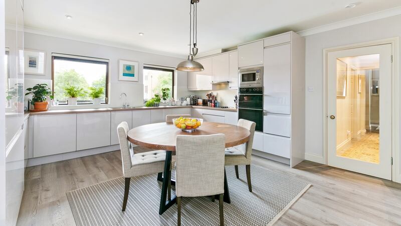 The smart kitchen/breakfastroom by Kitchen World has glossy taupe units