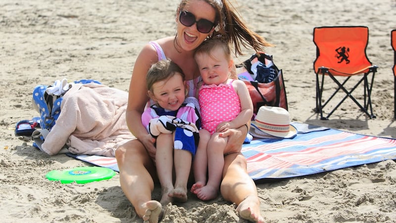 Louise Bruton with her children Hailey (3) and Willow (1)  from Meath enjoying the good weather on Portmarnock Beach on Monday. Photograph:  Collins