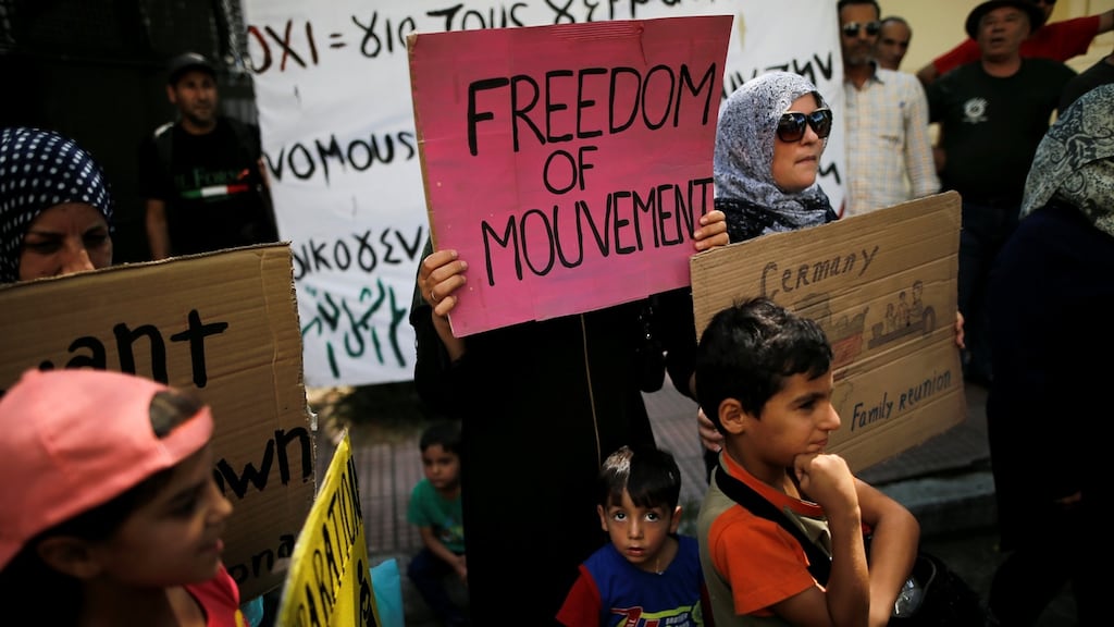 Syrian refugees hold banners during during a demonstration against delays in reunifications of refugee families from Greece to Germany, in Athens, Greece. Photograph: Alkis Konstantinidis/Reuters
