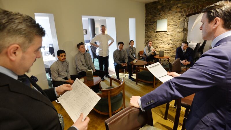 Darren Campbell (left), restaurant manager,  and Danny Desmond general manager, during the daily staff briefing