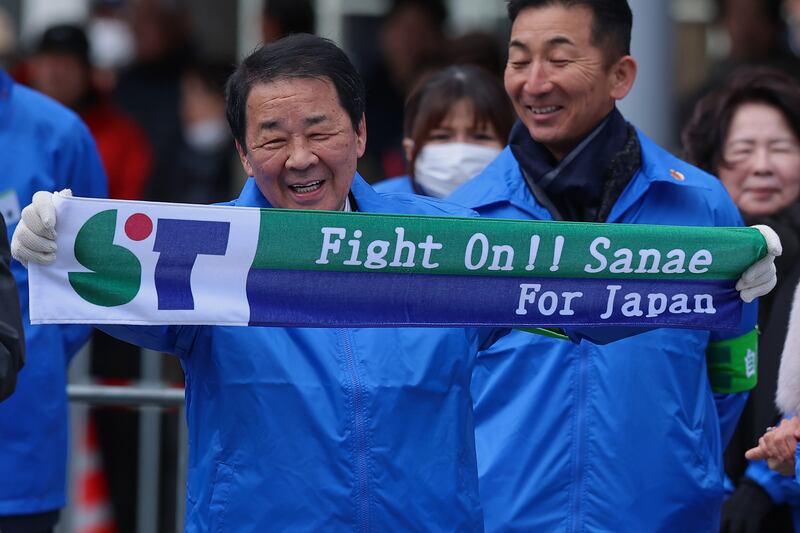 A Liberal Democratic Party supporter holds up a campaign towel during an election campaign rally. Photograph: Buddhika Weerasinghe/Getty Images