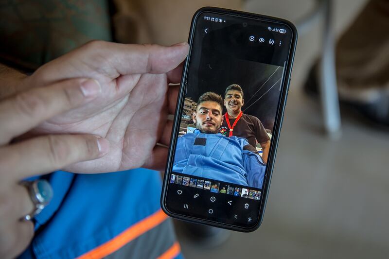 Mohammad Suleiman, chief of the Nabatieh Ambulance Service, shows a picture of his son Joud, who was killed aged just 15, with Ali Jaber, who was also killed. Photograph: Sally Hayden