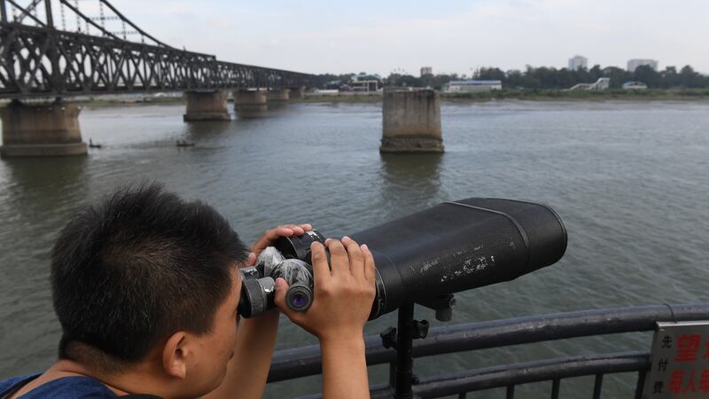 A man looks towards North Korea while visiting the Broken Bridge, in the border city of Dandong, in China’s northeast Liaoning province. Photograph: Greg Baker/AFP/Getty Images