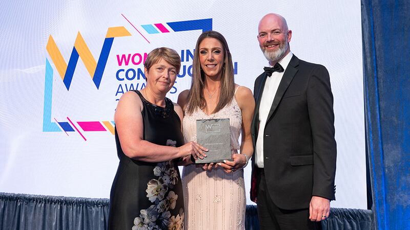 Susan Cormican, awards judge, presents the workplace of the year award to Jude Jackson and Michael Connolly, Heron Bros