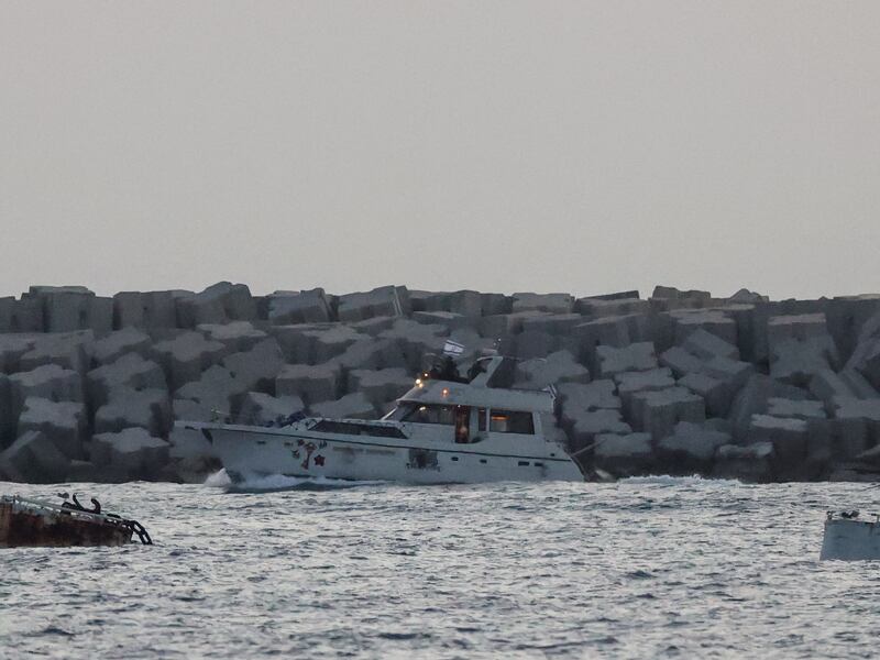 A boat carrying symbols of the Gaza-bound aid flotilla, which was intercepted by the Israeli navy, is driven towards the Israeli port of Ashdod. Photograph: Jack Guez/AFP/Getty