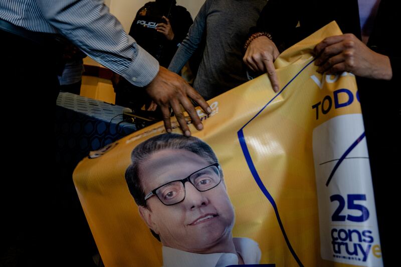 Supporters of the assassinated presidential candidate Fernando Villavicencio hold a banner with his face in Quito, Ecuador. Photograph: Johanna Alarcón/New York Times
                      