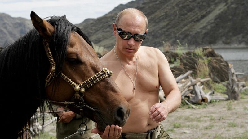 Russian Prime Minister Vladimir Putin with a horse. Photograph:  Alexey Druzhinin/AFP/Getty Images