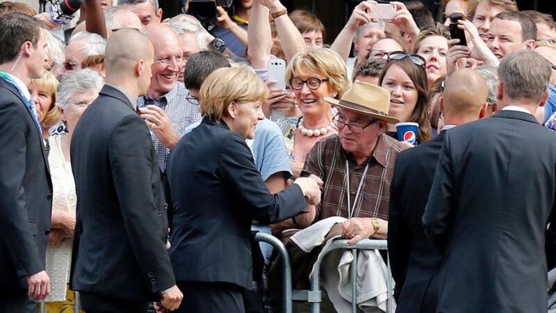 German chancellor Angela Merkel shakes hands with members of the public as she arrives in Ypres, Belgium, to commemorate the centenary of the start of the first World War. Photograph: Reuters/Pascal Rossignol
