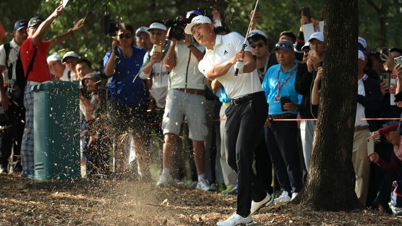 Haotong Li hits his second shot on the seventh. Photo: Andrew Redington/Getty Images