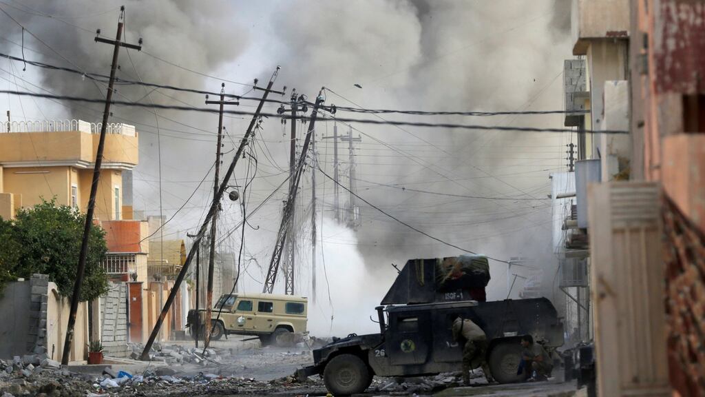 An Iraqi special forces soldier takes cover as  an Islamic State fighter detonates a car bomb in a suicide attack in Tahrir neighbourhood of Mosul last month. Europol warned on Friday that car bombs and kidnappings may become more common. Photograph: Reuters