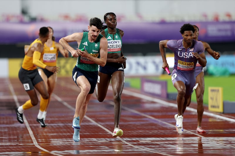Ireland's Cillín Greene takes the baton from Rhasidat Adeleke during the mixed 4x400m relay at the World Athletics Relays in Guangzhou. Photograph: Lintao Zhang/Getty Images for World Athletics