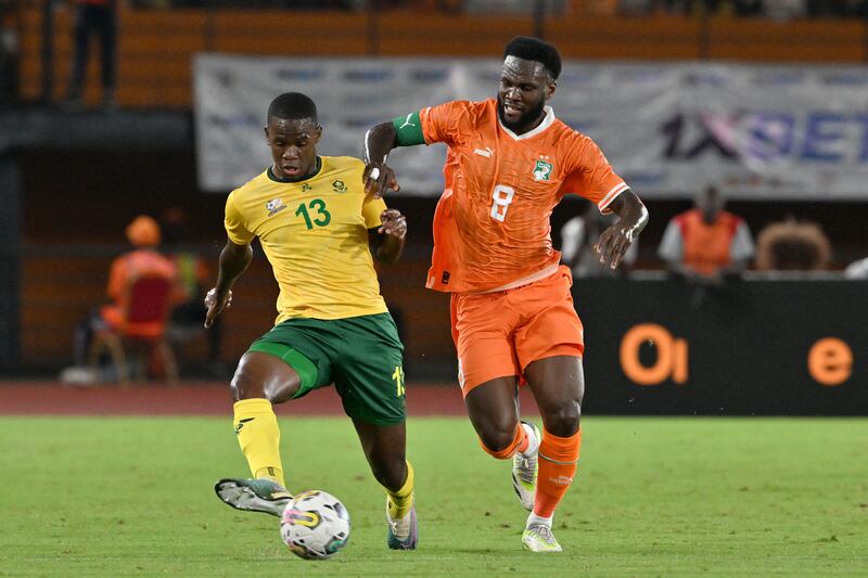 Sphephelo Sithone with Ivory Coast's Franck Kessié at Stade Felix Houphouet Boigny in Abidjan. Photograph: Issouf Sanogo/AFP via Getty Images