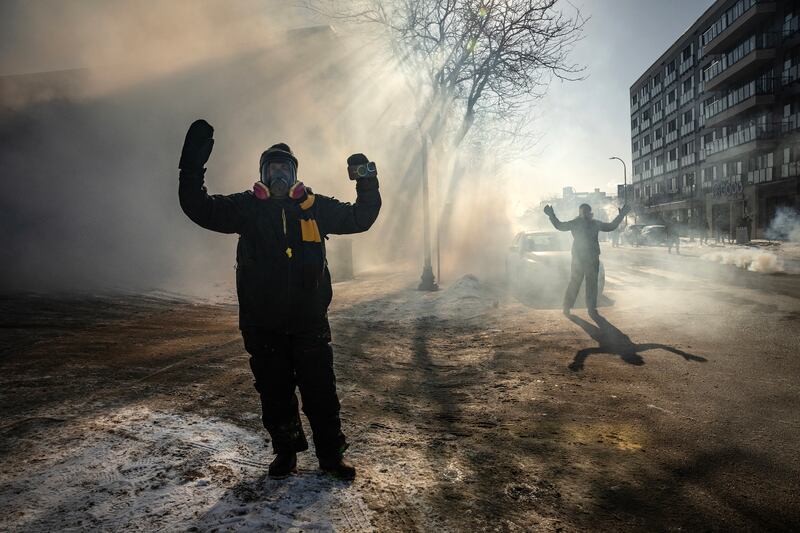 Protesters are surrounded by tear gas after confronting federal agents in Minneapolis, on Saturday, Jan. 24, 2026. (Photo by David Guttenfelder/The New York Times)