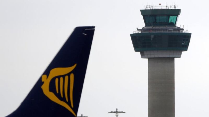 The tailfin of a Ryanair  jet passes a control tower at Stansted Airport near London. The airline has fired a pilot who questioned its safety record in a Channel 4 documentary. Photograph: Matthew Lloyd/Bloomberg.