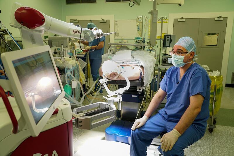 eaumount neurosurgeon Donncha O’Brien assesses Ray on the Rosa robot (left). Photograph: Enda O’Dowd/The Irish Times