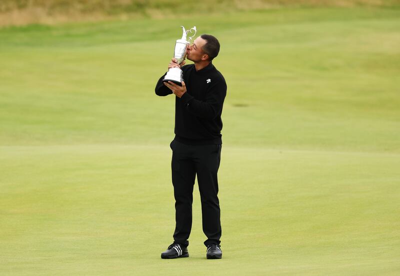 Xander Schauffele of the United States poses with the Claret Jug on the 18th green. Photograph: Kevin C Cox/Getty