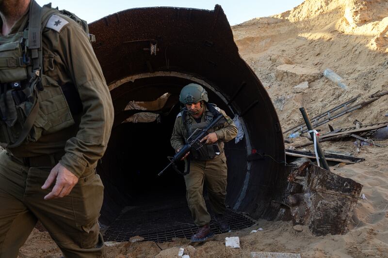 
Israeli soldiers leave what Israel says is the largest Hamas tunnel they have discovered so far in Gaza, located a few hundred meters from the Erez border crossing, during an escorted tour by the military for international journalists to view the tunnel on December 15th. Photograph: Tamir Kalifa/New York Times
                      