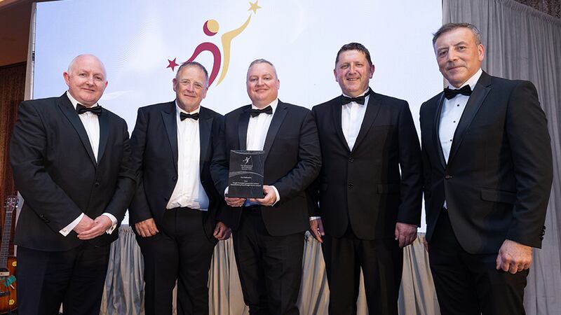 Odhrán Allen, awards judge, presents the best publication award to the Freight Transport Association Ireland team