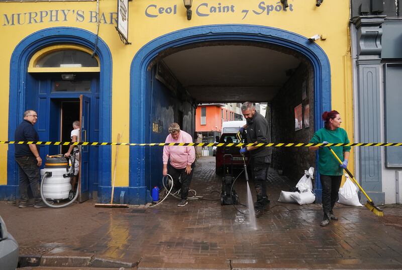 The clean-up is in full swing outside Murphy's Bar. Photograph: Brian Lawless/PA Wire