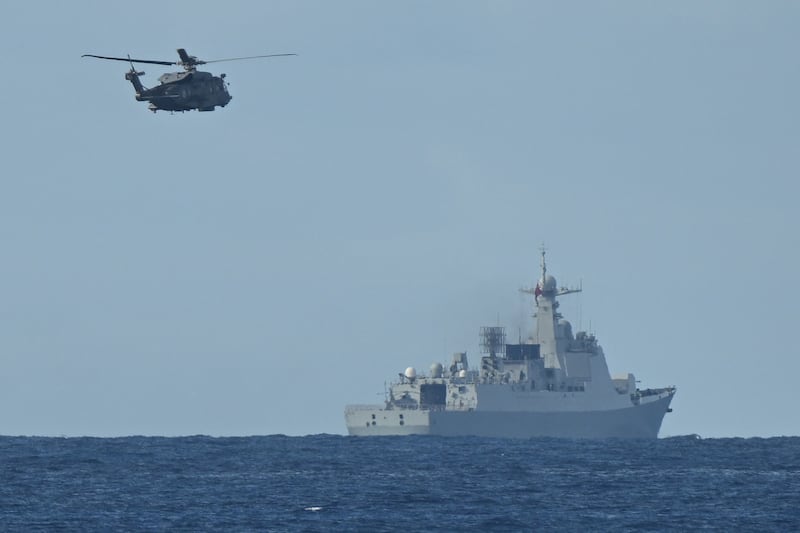 A Chinese PLA Navy ship in disputed waters of the South China Sea is trailed by a Canadian helicopter last September. Photograph: Ted Aljibe/AFP/Getty