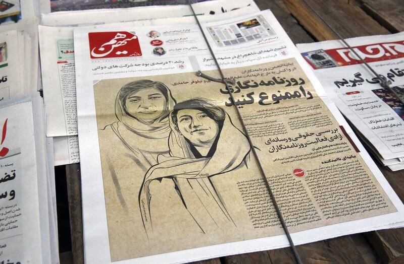 A copy of Iranian daily newspaper Hammihan with a drawing featuring two Iranian journalists Niloufar Hamedi and Elaheh Mohammadi with a title 'Ban the journalism' referring to the statement by the Tehran journalists' association against the prisoning journalists over covering protests in Iran. Photograph: Abedin Taherkenareh/EPA-EFE