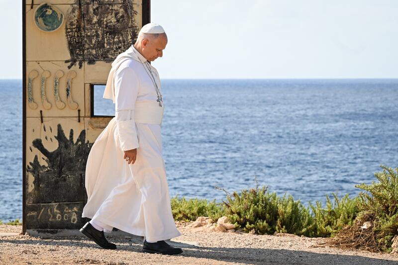 Pope Leo XIV walks through the arch of the monument Door of Europe - Porta d'Europa, made by italian artist Mimmo Paladino, during his visit to Lampedusa island, south of Sicily, in July 2026. Photograph: Tiziana FABI/AFP via Getty Images