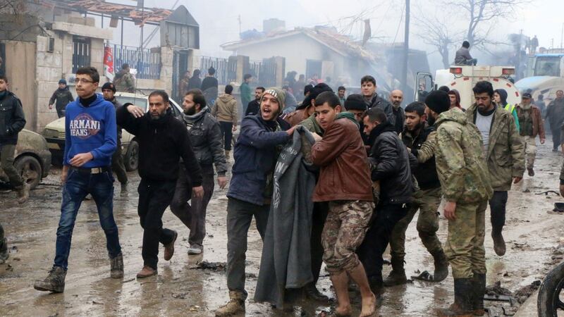 Rescue workers attend to those injured after they and Syrian’s opposition activists say dozens were killed when the car bomb went off. Photograph:  Saif Alnajdi/AP