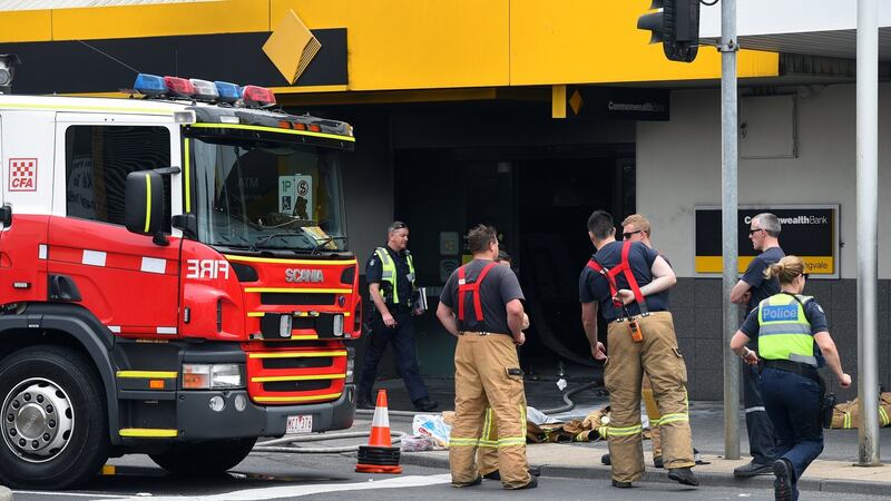Emergency service workers are seen at a branch of the Commonwealth Bank after. Julian Smith/Reuters