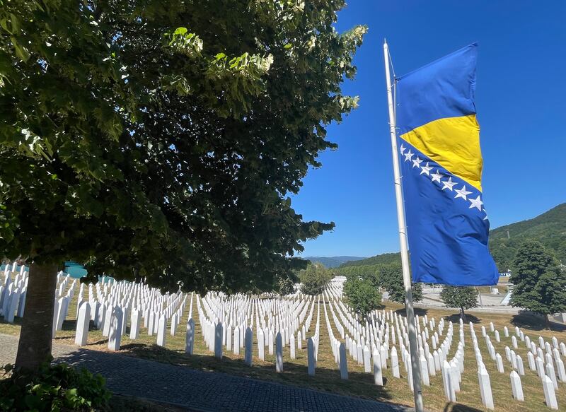 The Bosnian flag flies over the graves of many of the more than 8,000 Bosniak men and boys massacred by Serb forces in and around Srebrenica in July 1995. The cemetery at Potocari outside Srebrenica will host a 30-year commemoration event on Friday. Photograph: Daniel McLaughlin